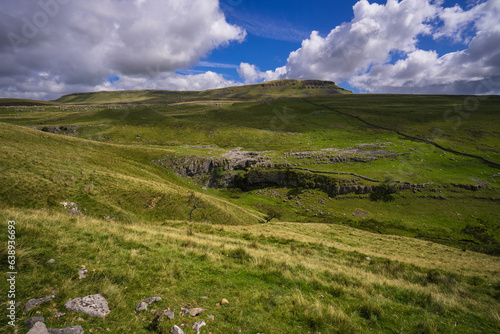 View of one of the three Yorkshire Peaks - Penyghent (Pen-y-ghent) in the Yorkshire Dales National Park. In the foreground is Horton Scar.