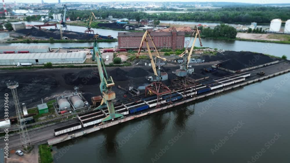 Cargo cranes load railroad cars with coal at a seaport. Industry, transportation, loading. 4k footage Cargo cranes load railroad cars with coal at a seaport. Industry, transportation, loading. 4k footage