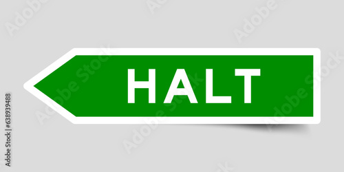 Green color arrow shape sticker label with word halt on gray background