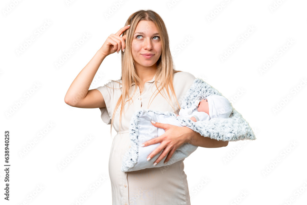 Obraz premium Young pretty pregnant woman with her newborn baby over isolated chroma key background having doubts and with confuse face expression
