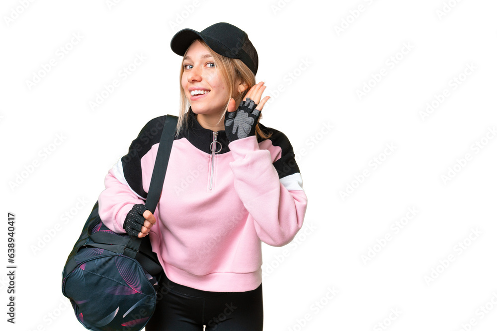 Pretty sport woman with sport bag over isolated chroma key background listening to something by putting hand on the ear Pretty sport woman with sport bag over isolated chroma key background listening to something by putting hand on the ear