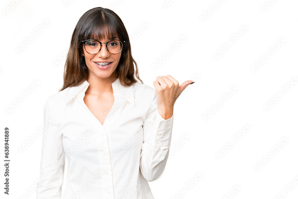 Young caucasian woman over isolated chroma key background pointing to the side to present a product Young caucasian woman over isolated chroma key background pointing to the side to present a product