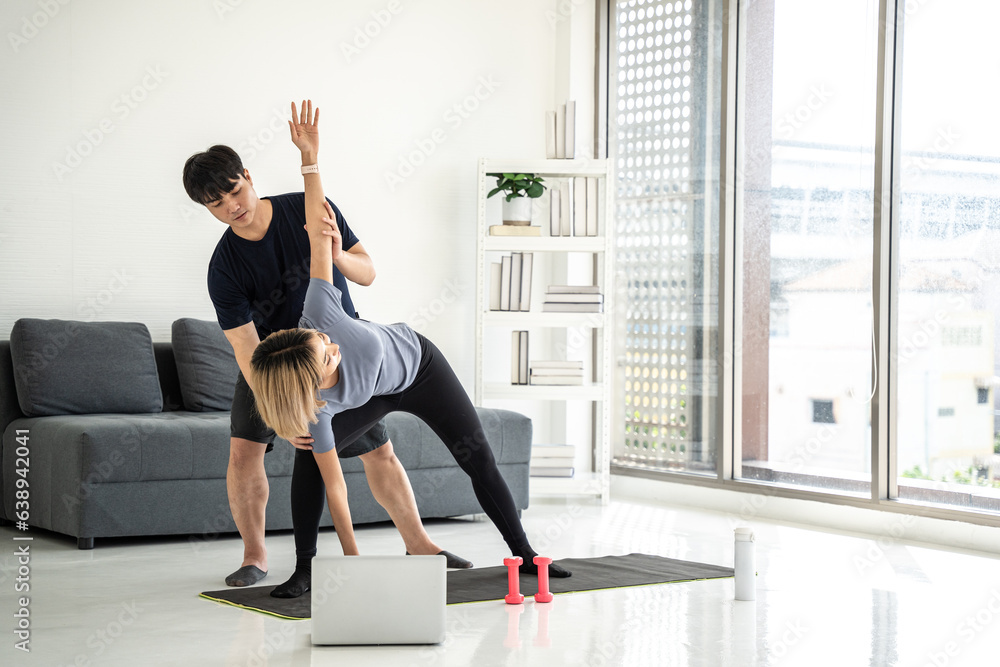Obraz premium Asian beautiful woman exercise with profession trainer at gym. Male trainer training her to exercise at fitness room.