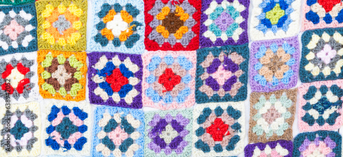 Multi colored blanket in wool, square geometric background, retro decorative pattern