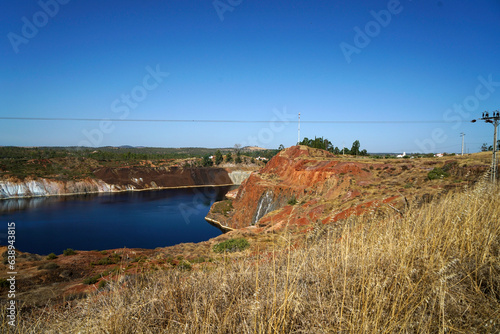 Contaminated pond lake of an old abandoned mining landscape for copper mining with red earth
