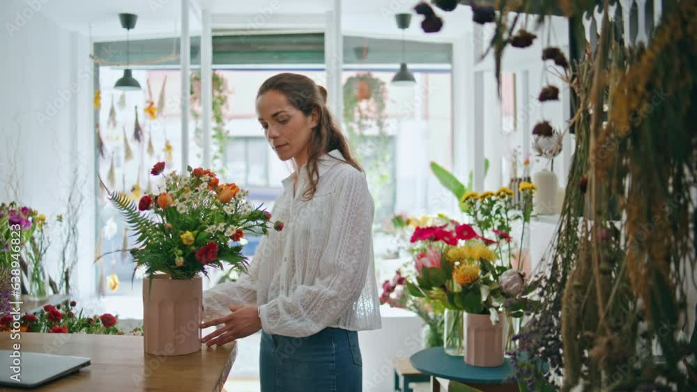 Flower store retailer work make bouquet in beautiful spring plant shop business. Flower store retailer work make bouquet in beautiful spring plant shop business.