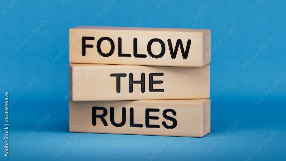 Follow the rules symbol. Concept words Follow the rules on wooden blocks. Business and follow the rules concept. Copy space.3D rendering on blue background.
 - obrazy, fototapety, plakaty 