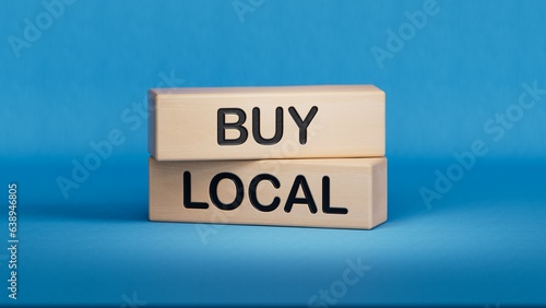 Time to buy local symbol. Wooden blocks with words 'Buy local'.  Business and time to buy local concept. Copy space.3D rendering on blue background.
