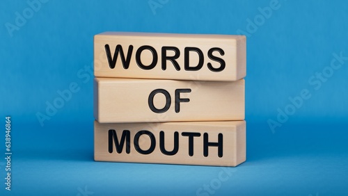 Words of mouth symbol. Concept words Words of mouth on wooden blocks. Business, finacial and words of mouth concept. Copy space.3D rendering on blue background.

