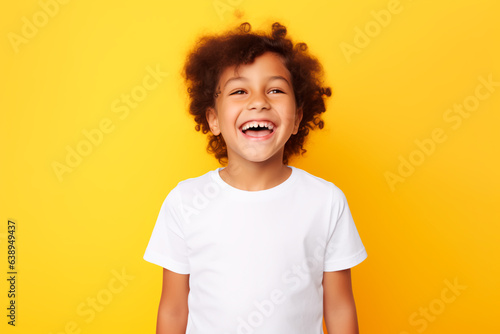 Happy child on a yellow background. Joyful baby © Uliana