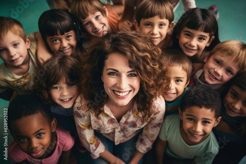 A group portrait of a teacher and her diverse class of elementary school students photo