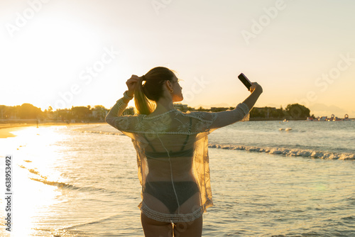girl taking a selfie on the beach