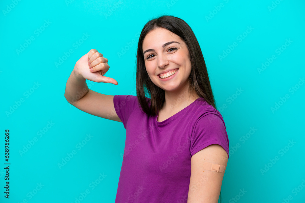Young girl with band-aids isolated on blue background proud and self-satisfied Young girl with band-aids isolated on blue background proud and self-satisfied