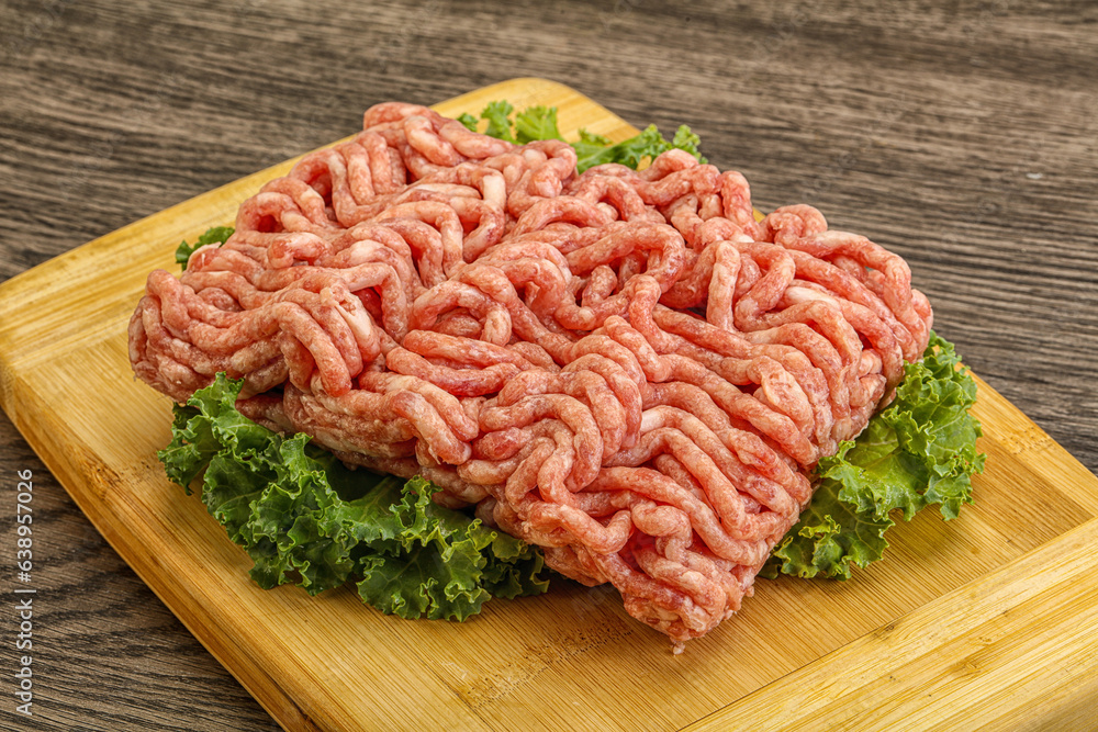 Raw pork minced meat over board Raw pork minced meat over board