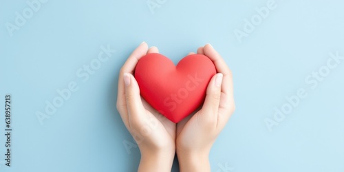 Young women hands holding red heart on light blue background, health care, donate and family insurance concept, world heart day, world health day, CSR responsibility, generative ai