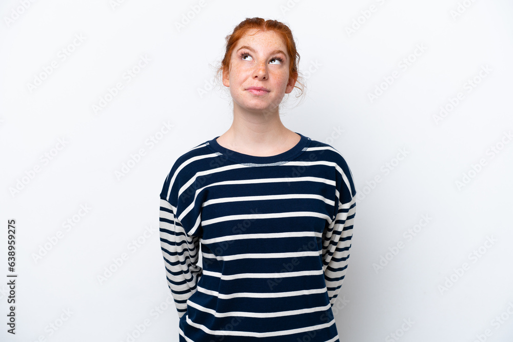 Young reddish woman isolated on white background and looking up Young reddish woman isolated on white background and looking up