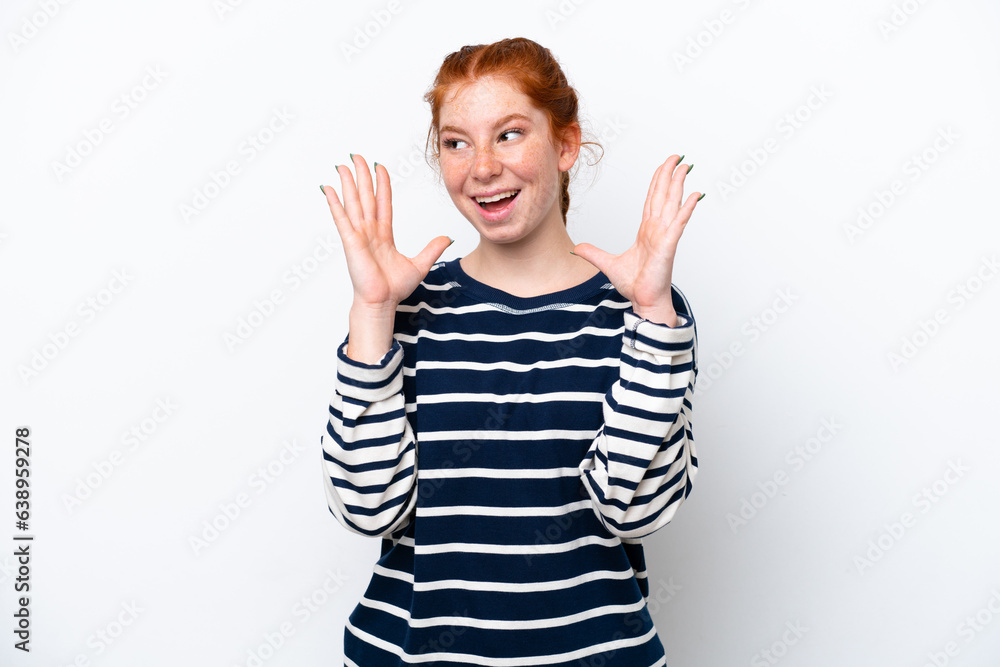 Young reddish woman isolated on white background with surprise facial expression Young reddish woman isolated on white background with surprise facial expression