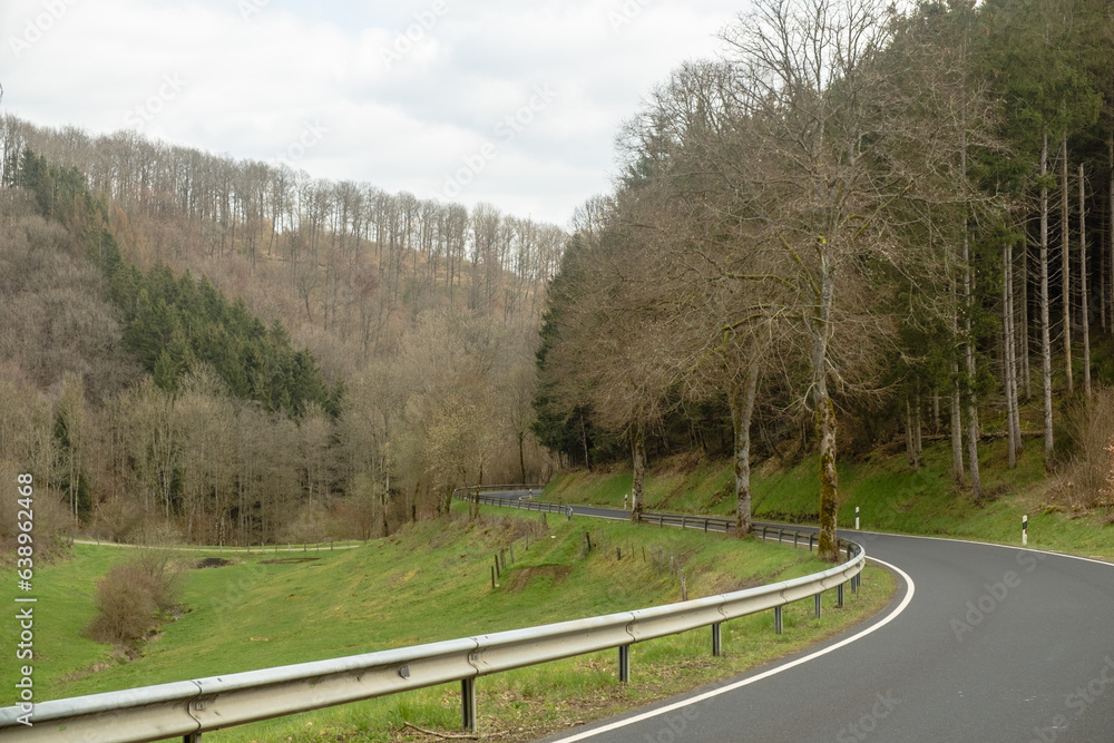 Winding road with guardrails in Clervaux, Luxembourg