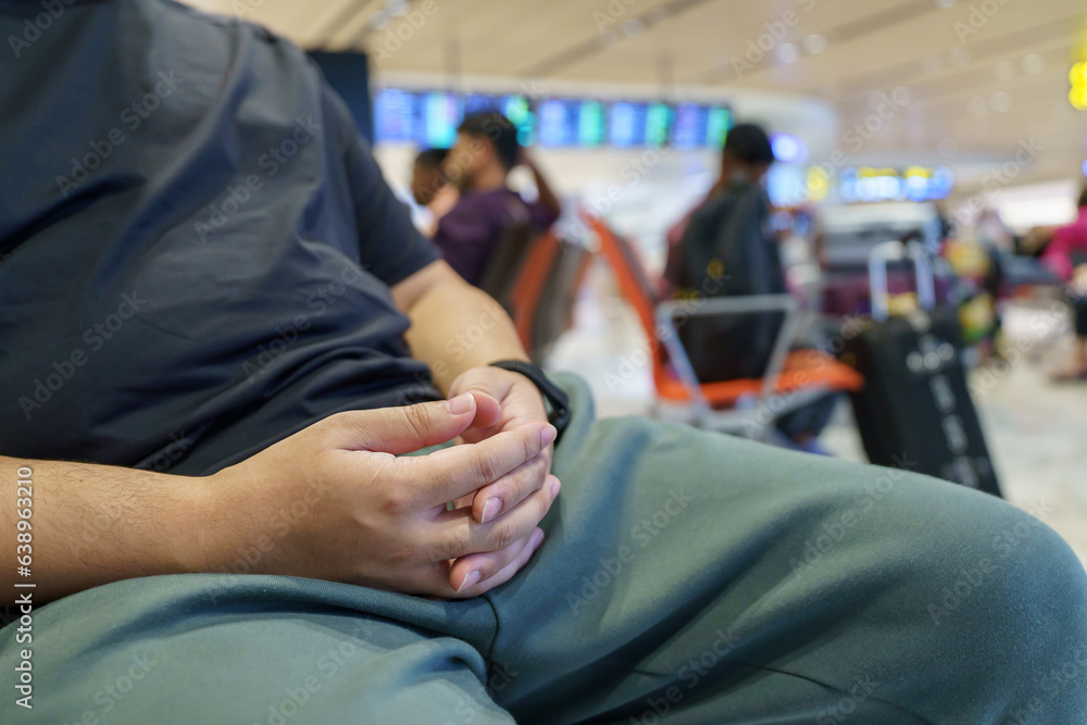 Man waiting for flight in airport departure area at airport waiting the flight Man waiting for flight in airport departure area at airport waiting the flight