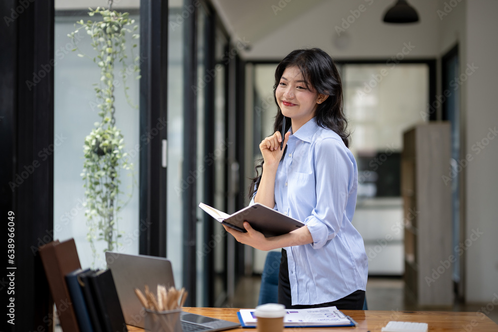 Businesswoman busy thinking and writing a new project Businesswoman busy thinking and writing a new project