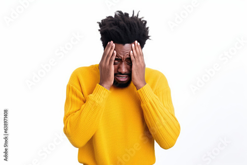 The Man Has A Headache. Sadness African Man In Yellow Sweater On White Background photo