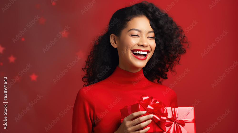 Happy smiling woman holding gift box over red background Happy smiling woman holding gift box over red background