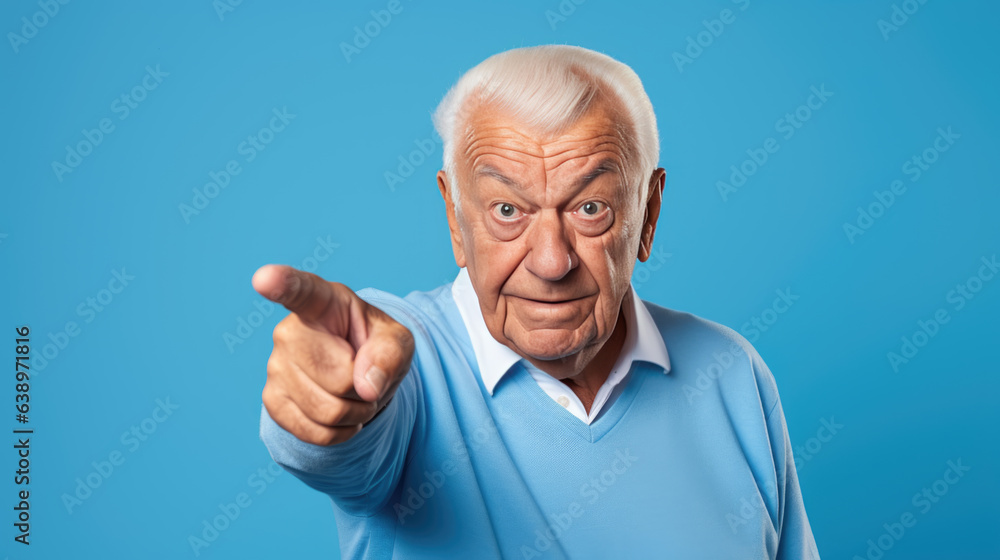 Senior man pointing with hand and finger to the side looking at the camera. Senior man pointing with hand and finger to the side looking at the camera.