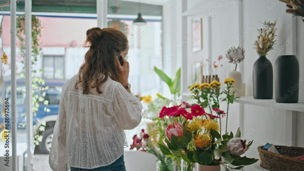 Florist businesswoman call phone to customer buyer. Busy girl speak digitally. Florist businesswoman call phone to customer buyer. Busy girl speak digitally.