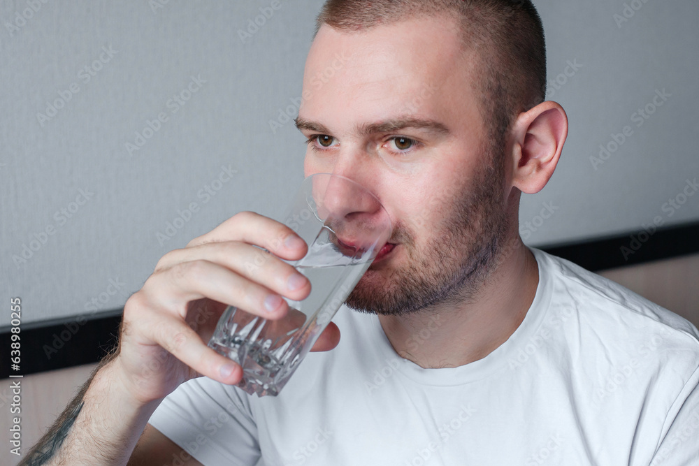 Man drinking water from a glass Man drinking water from a glass