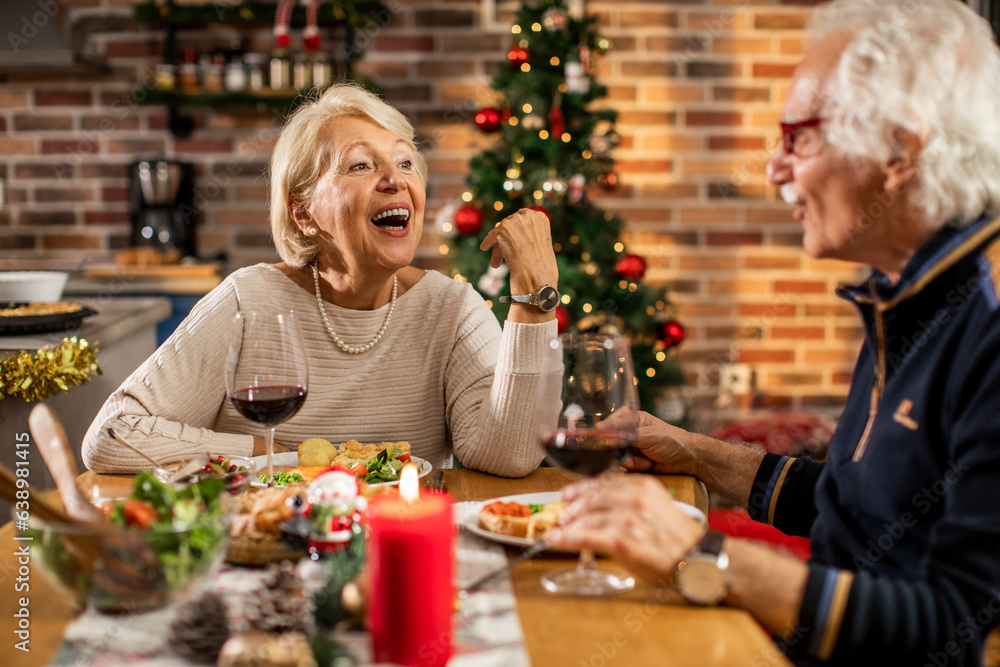 Senior caucasian couple having a romantic dinner together at home during christmas and the new year holidays