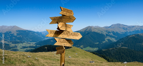 Fotografie wooden pointer with directions to mountain peaks with indications of the height