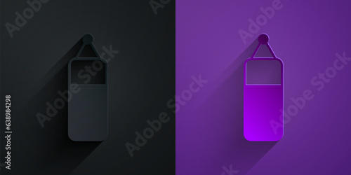 Paper cut Punching bag icon isolated on black on purple background. Paper art style. Vector