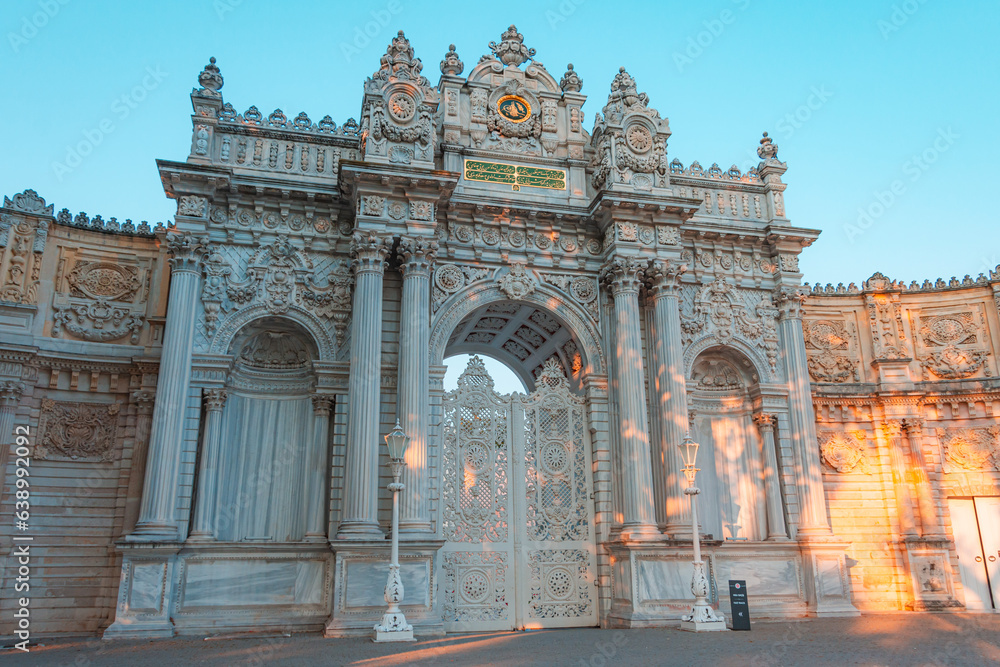 Sunset shot of closed gate leading to former Ottoman Dolmabahce Palace, or Dolmabahce Sarayi, suited in Ciragan Street, Besiktas district, Istanbul, Turkey.