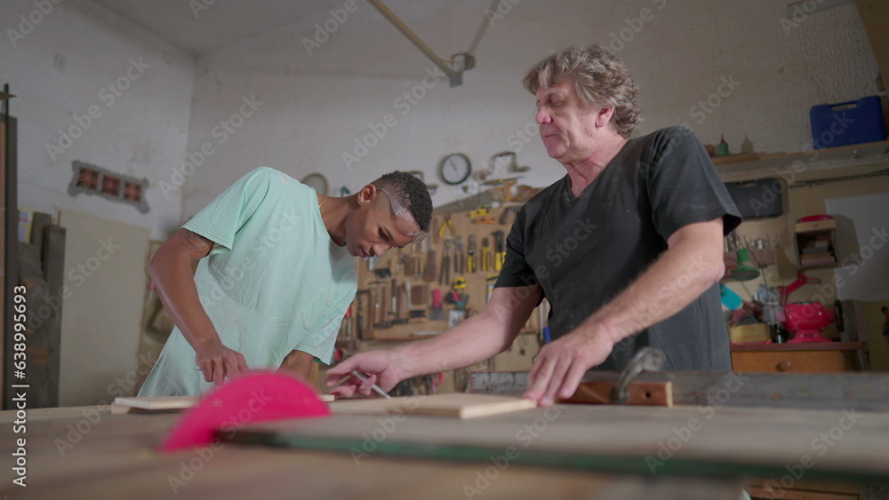 Master carpenter guiding student apprentice at carpentry workshop, job occupation profession process. Senior man teaching student Master carpenter guiding student apprentice at carpentry workshop, job occupation profession process. Senior man teaching student