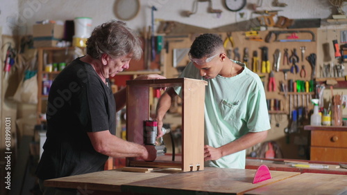 Senior Carpenter and Young Apprentice Collaborating in Carpentry Workshop