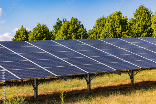 Rows of solar panels of a solar farm generating renewable electricity
