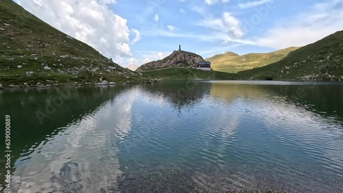 One of the most beautiful mountain lakes in Carnia. During a summer day with clouds in the background and few people. Volaia lake, mountain lake on the Italian and Austrian border. GoPro Hero 11. photo