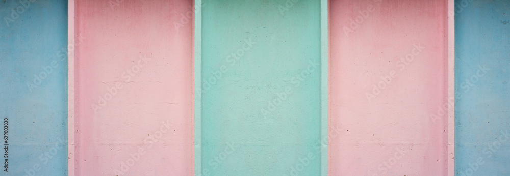 Fototapeta premium Horizontal banner with blue, green and pink stripes. Seamless pattern. Concrete wall. Pastel muted color. Wide line. Bold minimalism. Copyspace. Retro. Multicolored building fence. Minimalism for kids