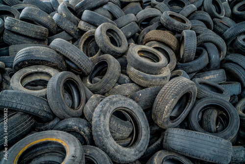 Used tires at recycling garbage field. Old tires trash storage.