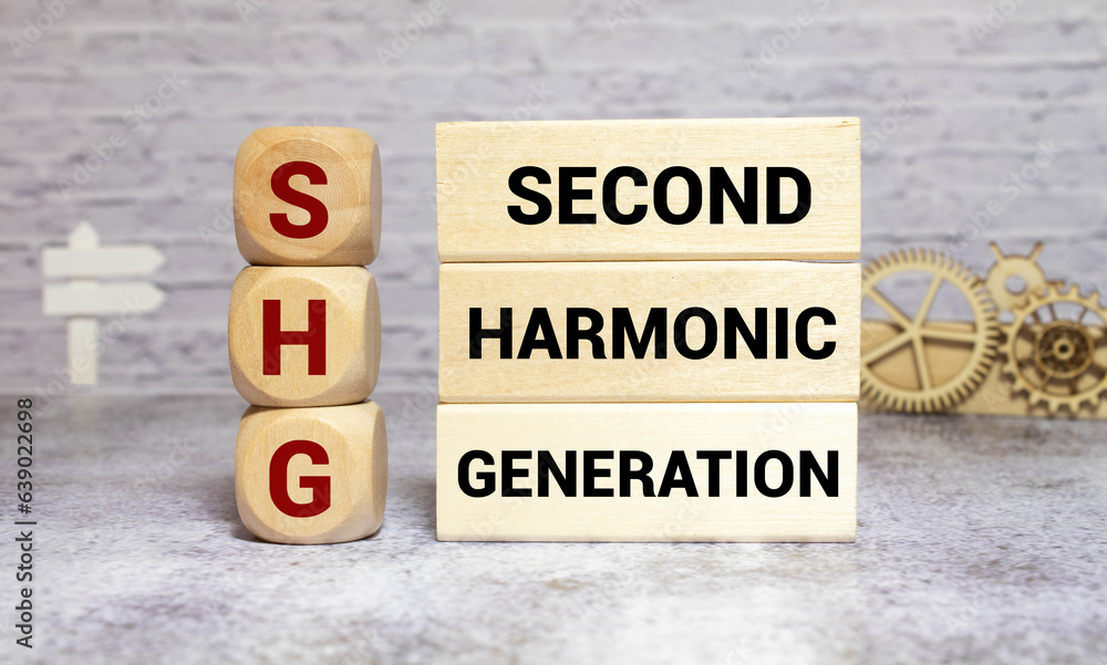 SHG - Second Harmonic Generation acronym text on notepad, abbreviation concept background.
