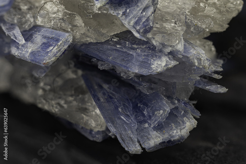 Striking blue kyanite crystal specimen showcased against a dark backdrop, capturing its mesmerizing allure
