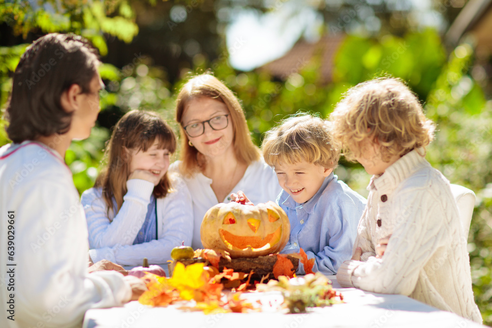 Family carving pumpkin for Halloween Family carving pumpkin for Halloween
