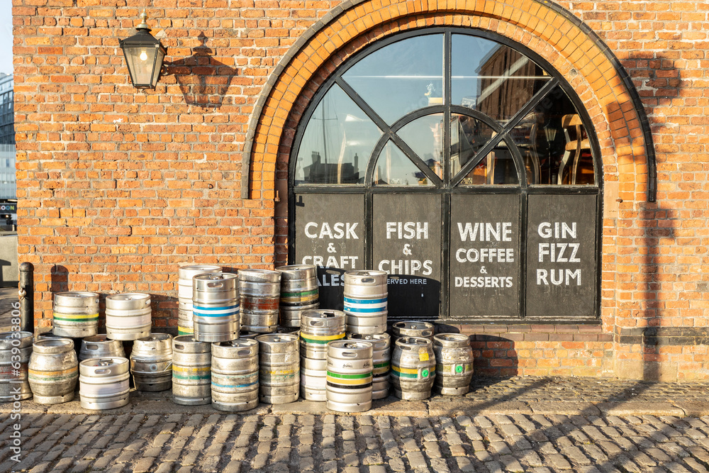 Liverpool, united kingdom May, 16, 2023 Aluminium beer kegs with brick