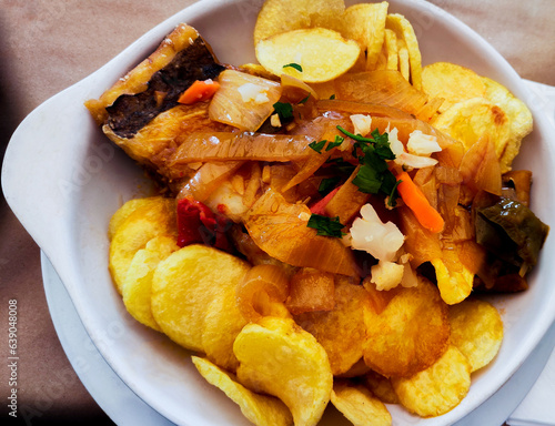 portuguese cod dish with potatoes or bacalhau à Margarida da Praça peppers and onion photo