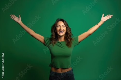 Happy 20 years old woman raises her arms - studio photo