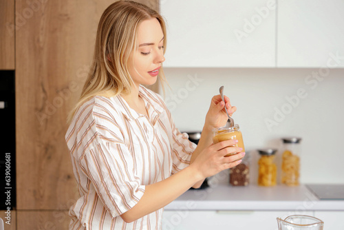 Young woman with spoon and ...
