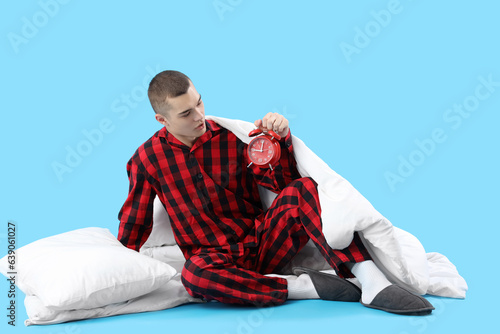 Young man in pajamas and wi...