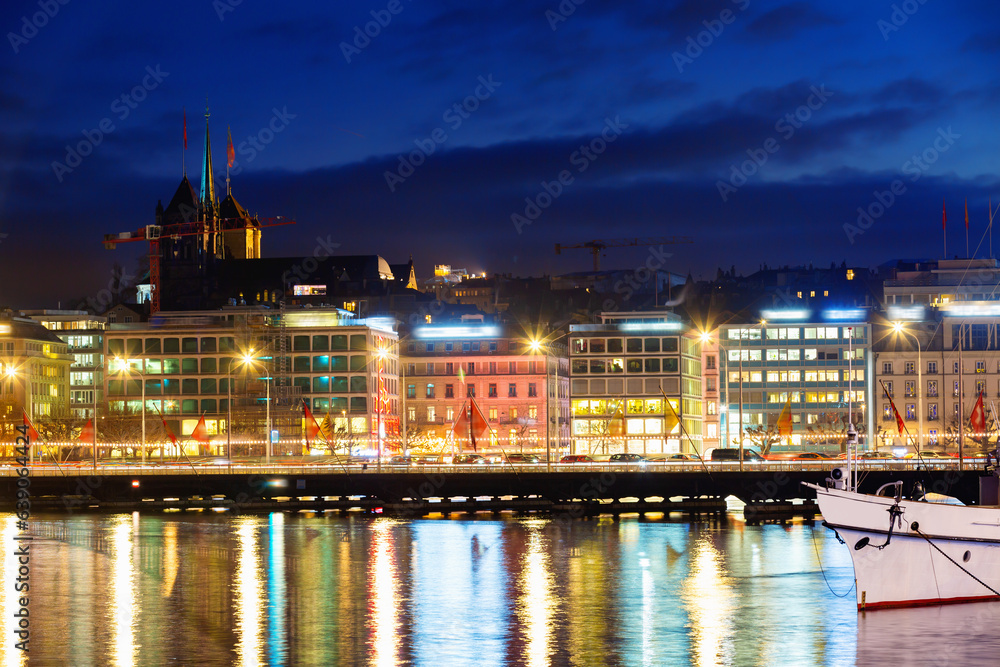 Cityscape of Geneva embankment in evening. View of residential and commercial buildings.