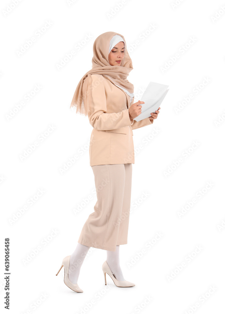 Portrait of pretty Muslim businesswoman with papers walking on white background Portrait of pretty Muslim businesswoman with papers walking on white background