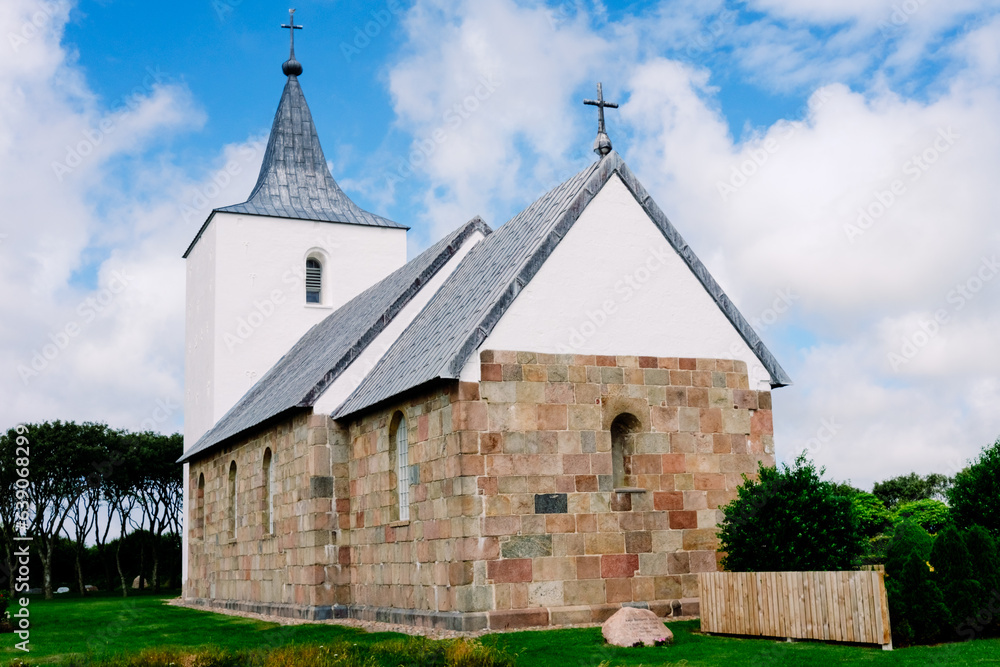 A serene vintage Protestant church nestled in the tranquil Danish countryside